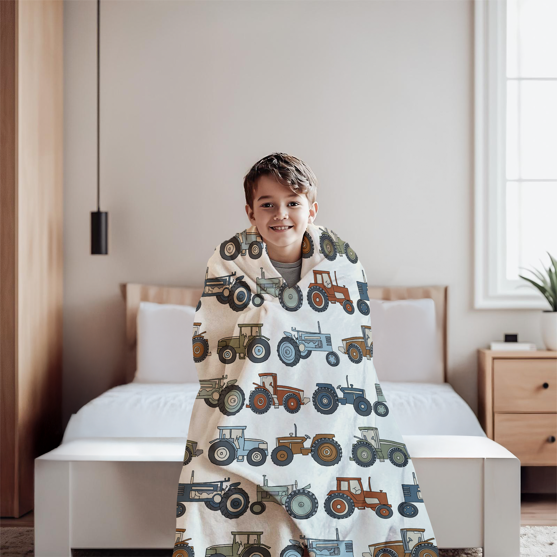 Child wrapped in a blanket with tractor pattern in a bedroom
